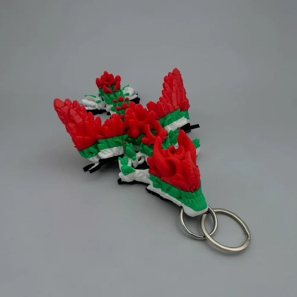 Winged Lunar Dragon: red and green dragon keychain, bat-like wings with segmented finger bones