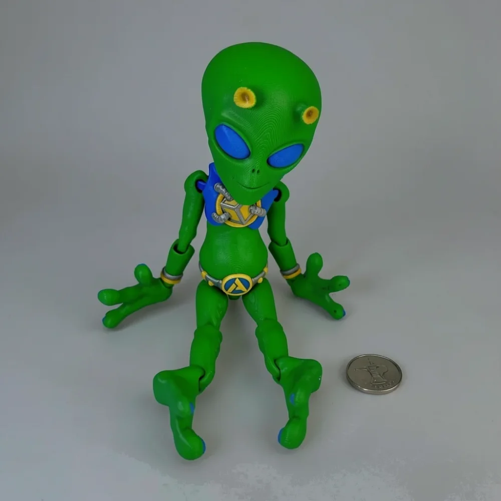 Alien: green and blue articulated alien action figure, large bulbous head with almond-shaped blue eyes