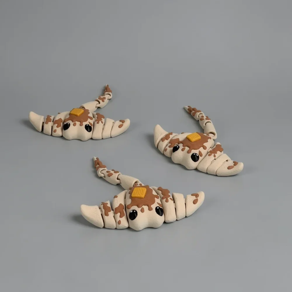 Flappy Jack Stingray: creamy off-white and brown croissant-caterpillar hybrid figurine (three identical pieces)