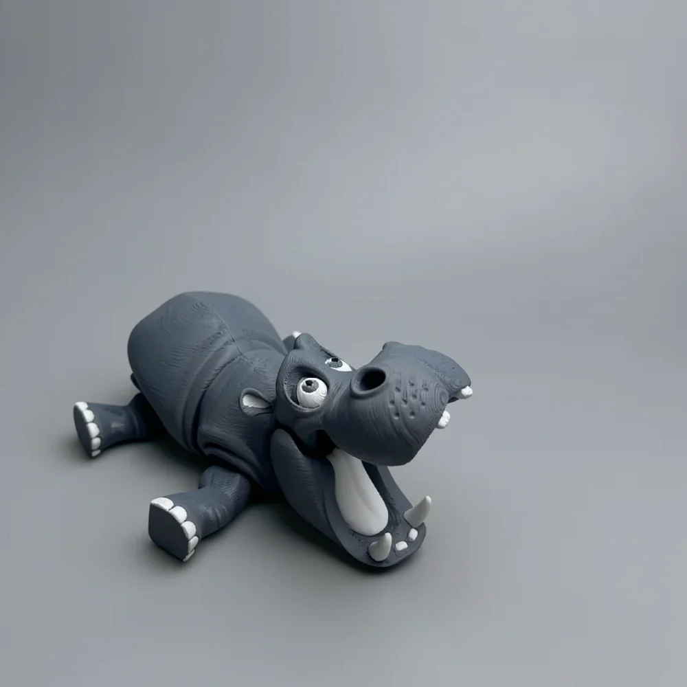 Hippo: grey and white cartoon hippopotamus figurine, large white bulbous eyes with small black pupils looking upward