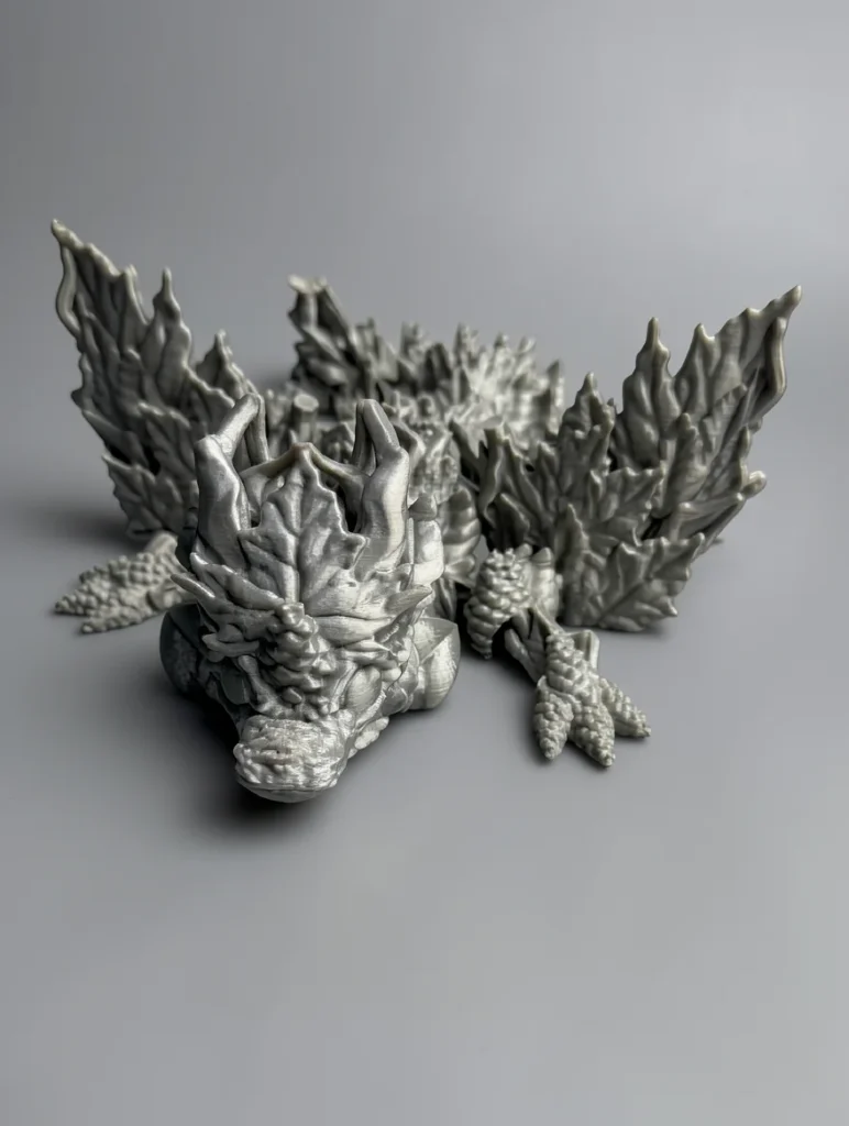 Baby Winged Autumn Dragon: grey dragon figurine with crystalline rock styling, jagged crystalline horn structures