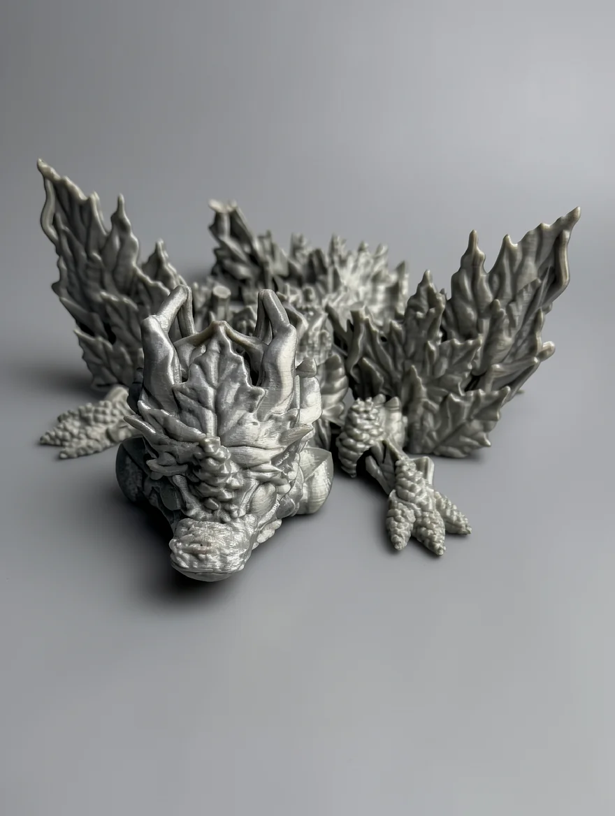 Baby Winged Autumn Dragon: grey dragon figurine with crystalline rock styling, jagged crystalline horn structures