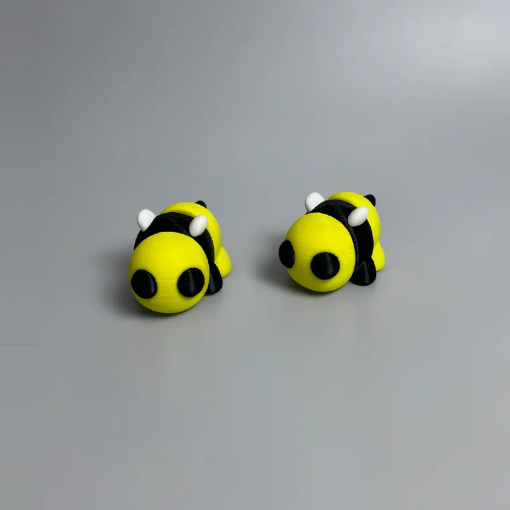 Baby Bee: yellow and black Two bumblebee figurines, large bulbous yellow head on each figurine