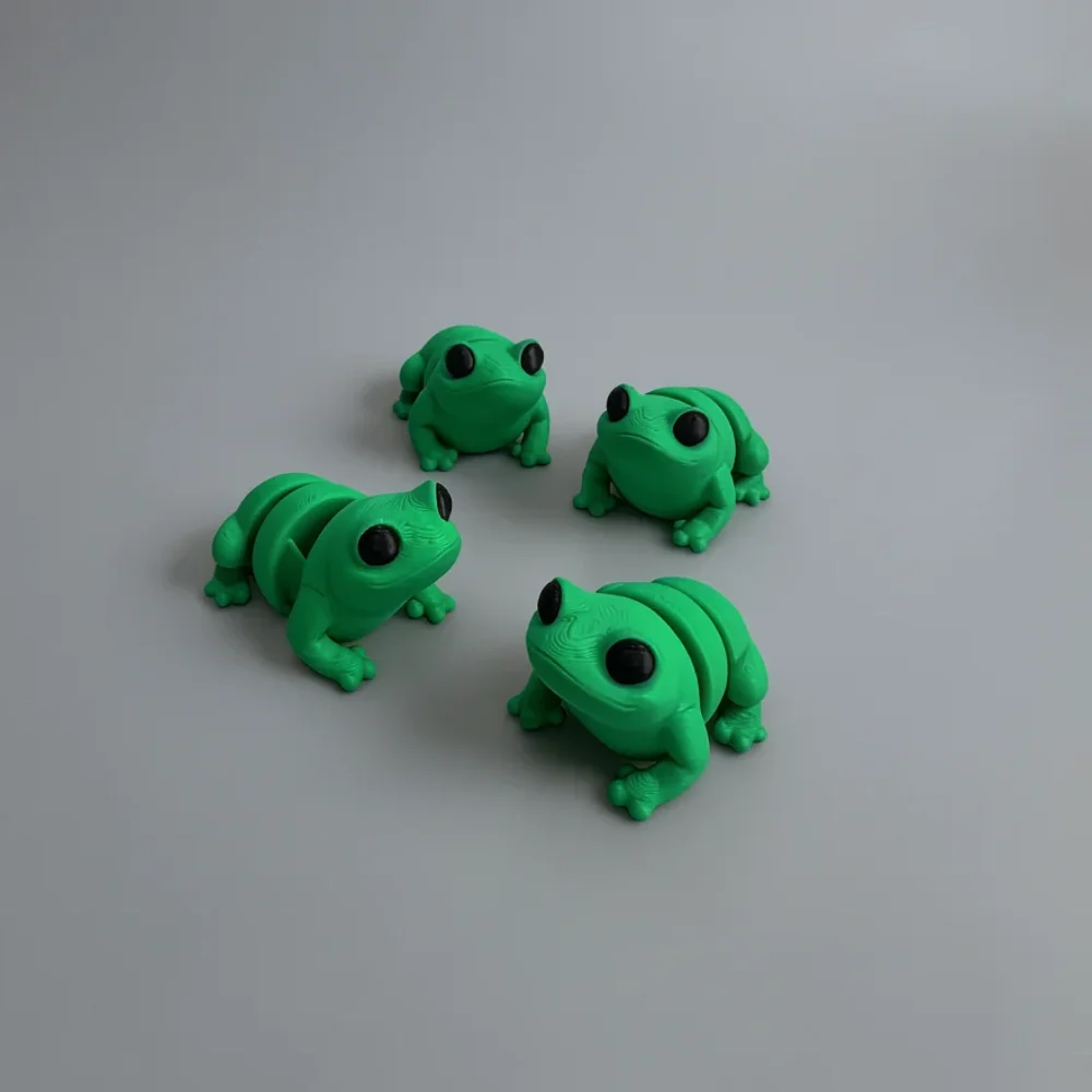 Baby Frog: green and black four frog/toad figurines, large prominent spherical black eyes
