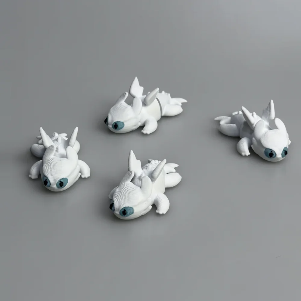 Baby Light Fury: white and teal-blue dragon figurines (four separate pieces)