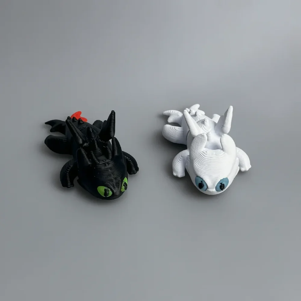 Baby Light Fury: grey and red-orange dragon figurine, large round eyes