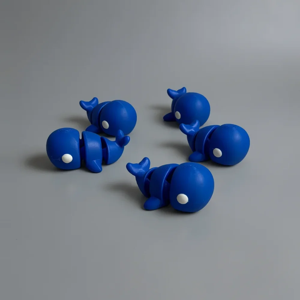 Baby Blue Whale: blue and white articulated whale figure, segmented body with visible seams/joints