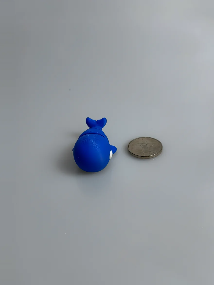 Baby Blue Whale: blue and white whale figurine, concentric circular layer lines on top of back