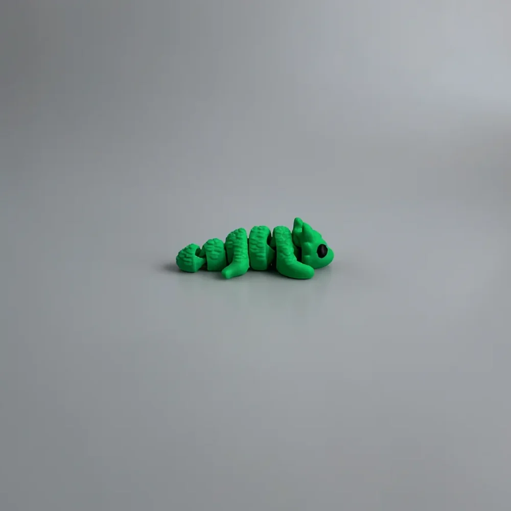 Baby Lucky Clover Dragon: green and black segmented caterpillar or worm figurine