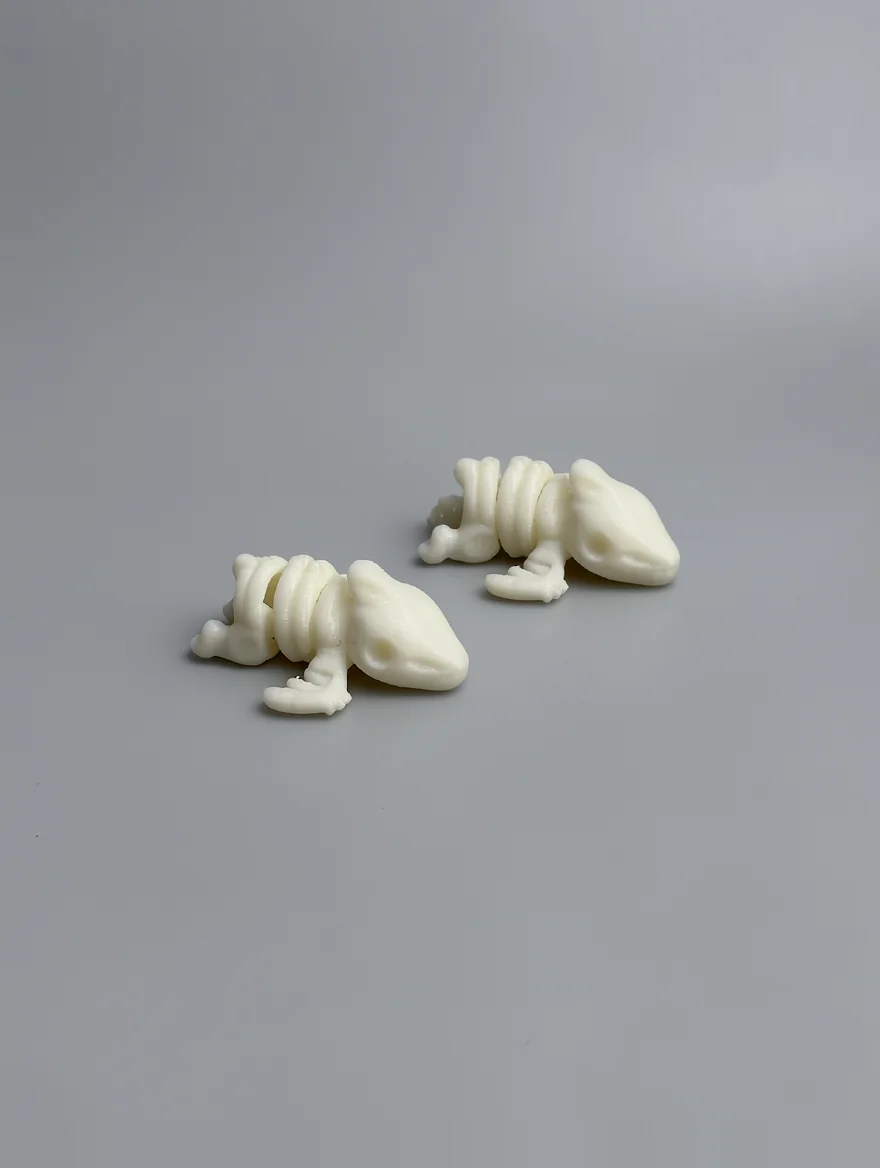 Baby Pterodactyl Skeleton: creamy white and off-white Two identical segmented creature figurines (stylized…