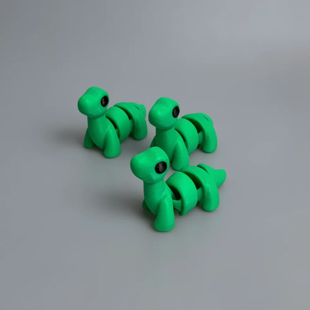 Baby Brontosaurus: green and black segmented dinosaur/dragon figurine, segmented/overlapping body sections