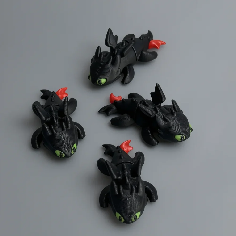 Baby Toothless: black and green four dragon figurines (articulated, single-piece each), bright green eyes