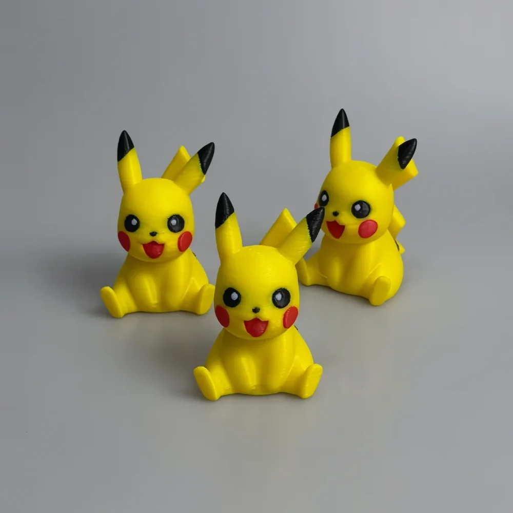 Pikachu: yellow and black three small Pikachu figurines, round head with large black eyes and white catchlights