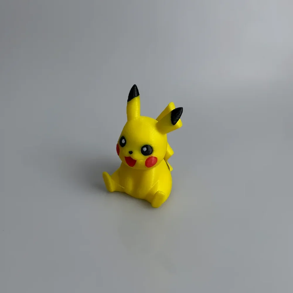 Pikachu: yellow and black Pikachu figurine, long pointed ears with black tips