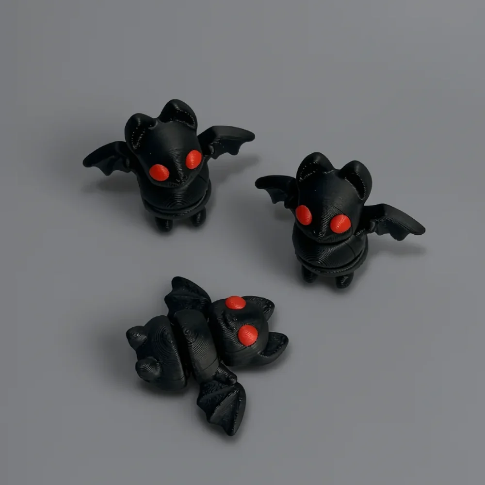Tiny Bat: black and red cat-bat hybrid figurine, pointed cat-like ears