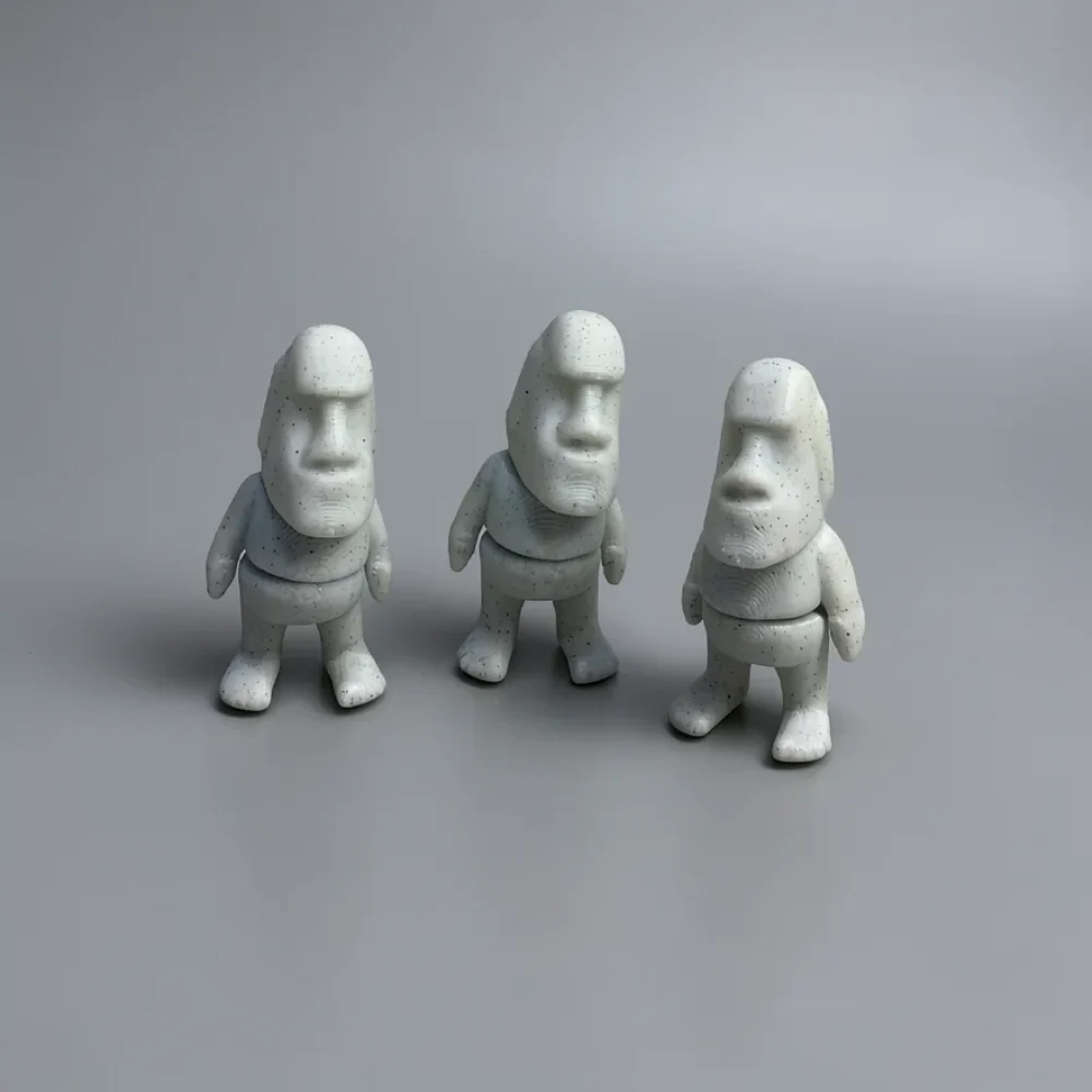 Tiny Moai: Creamy off-white and dark grey speckles Three Moai figurines (Easter Island statues) in chibi style with large…