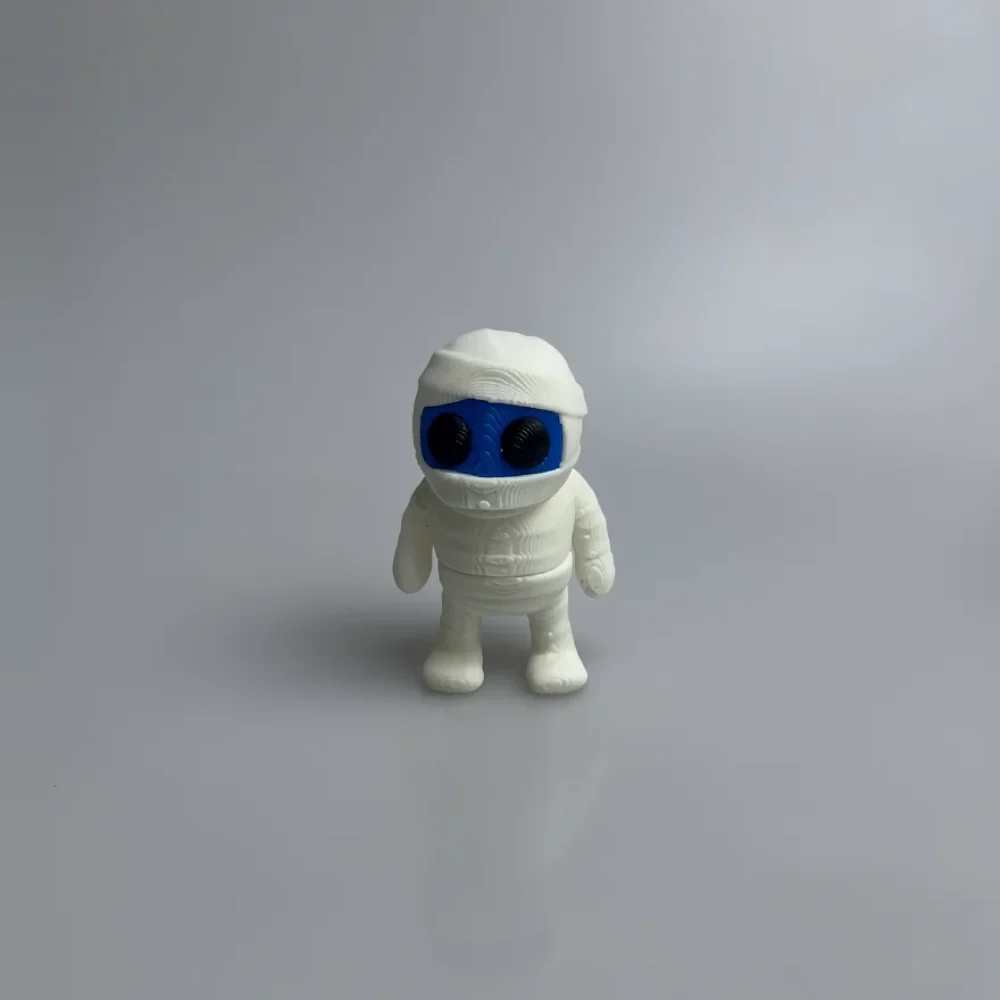 Tiny Mummy: white and blue mummy figurine, white bandage wrapping on head and body