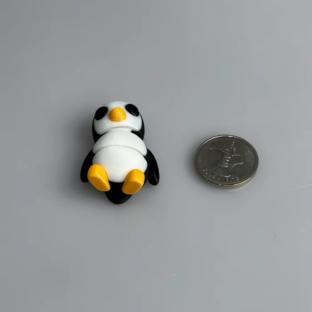 Tiny Penguin: black and white penguin figurine, black eye patches (eye-mask pattern on white face)