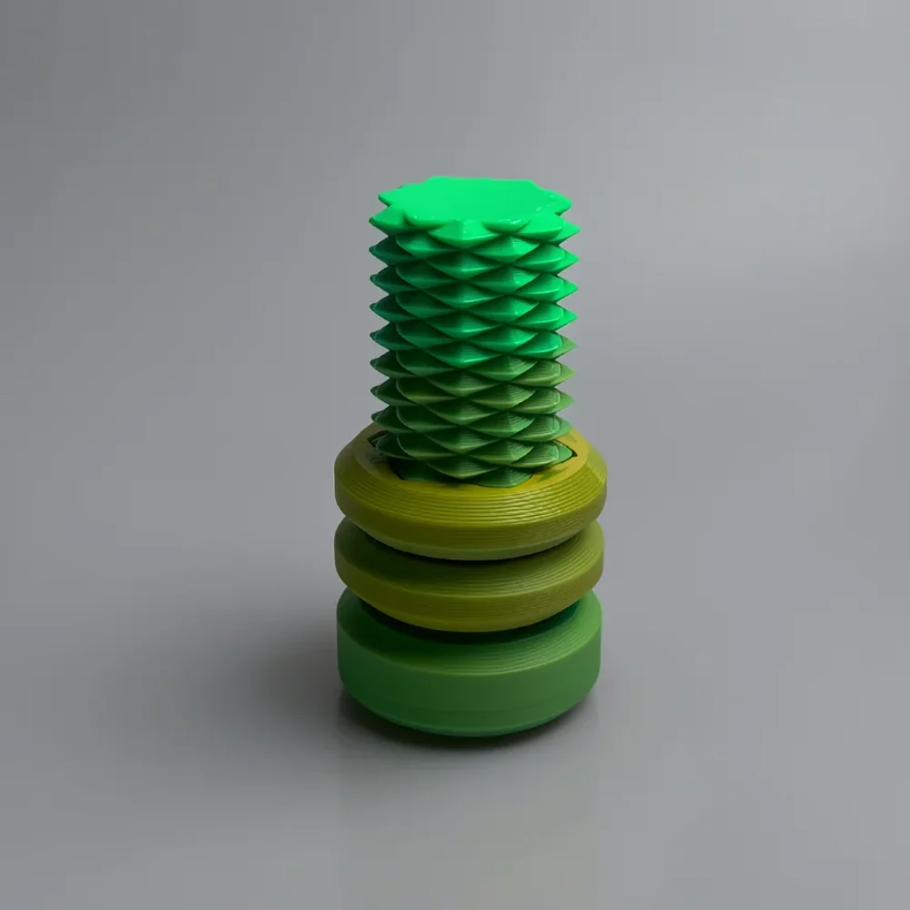 Two Way Screw: green and yellow-green geometric botanical sculpture, spiral scale-like segments on upper section