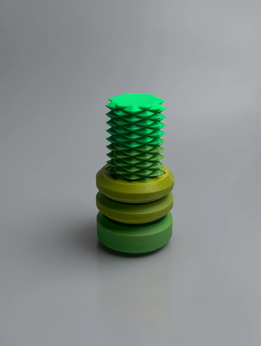 Two Way Screw: green and yellow-green geometric botanical sculpture, spiral scale-like segments on upper section