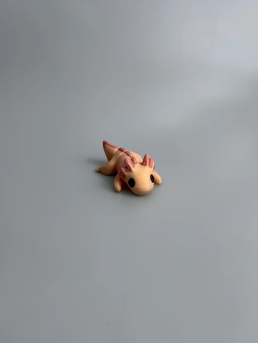 Baby Axolotl: pale peach and dusty pink axolotl figurine, three segmented gill stalks on each side of head
