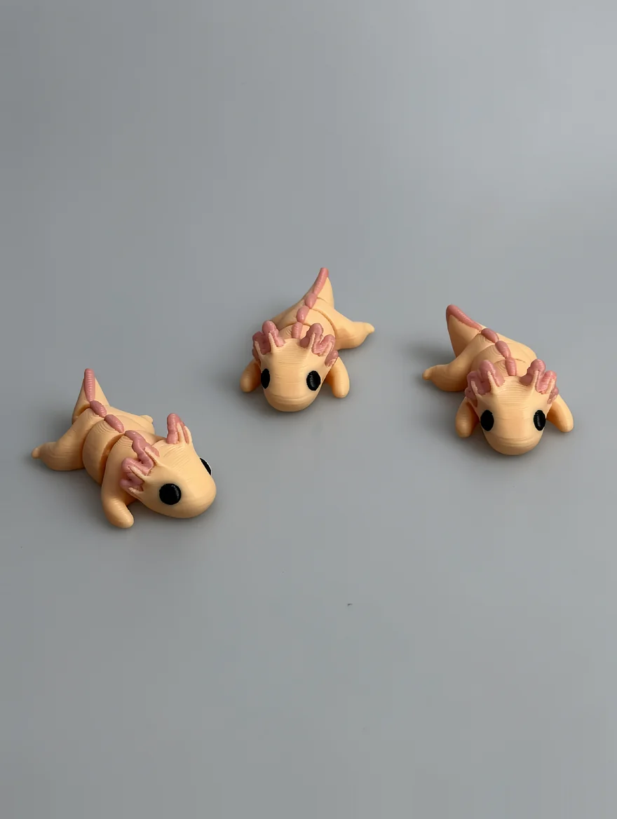 Baby Axolotl: pale creamy yellow and dusty pink three small axolotl figurines, each a single connected piece
