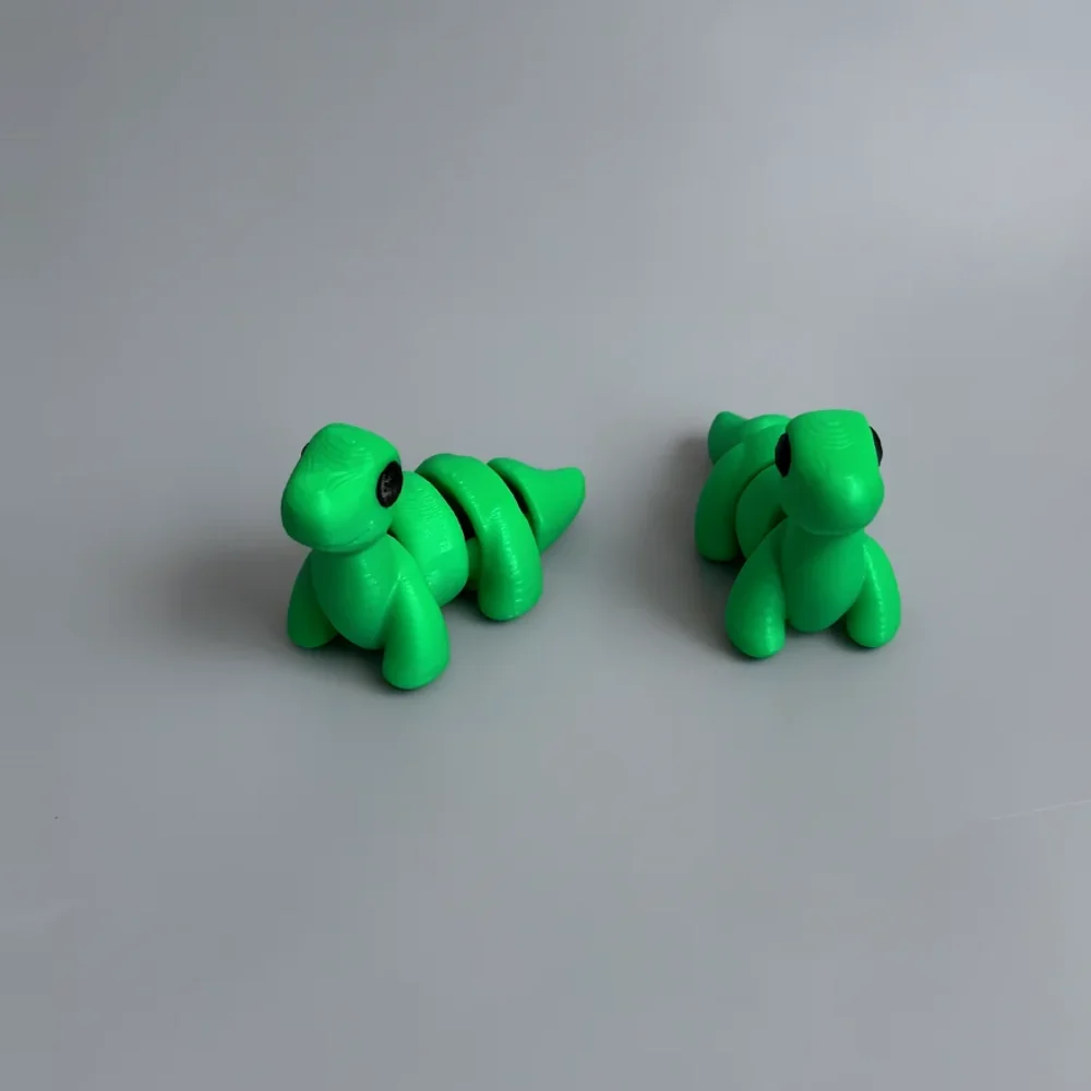 Baby Brontosaurus: green and black segmented dinosaur/dragon figurine (articulated, not modular), segmented bead-like spine