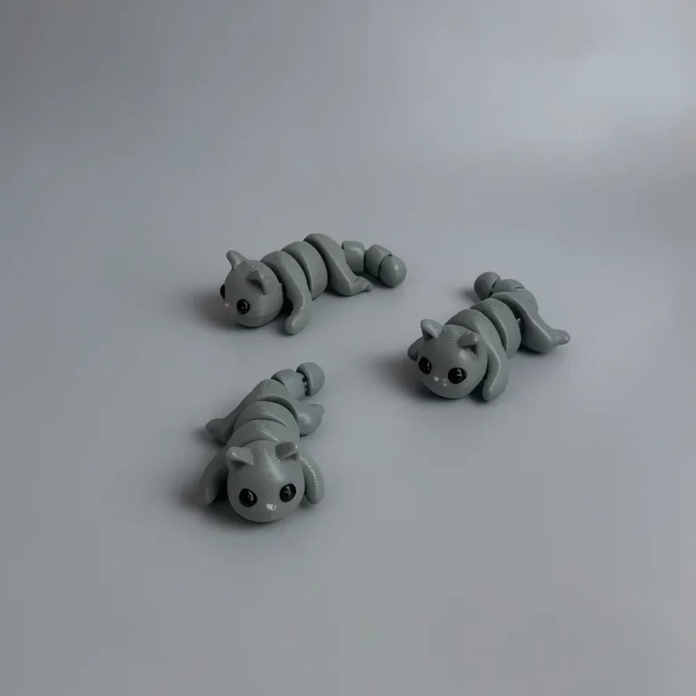 Baby Cat: light grey and black three identical articulated cat figurines, articulated segmented body