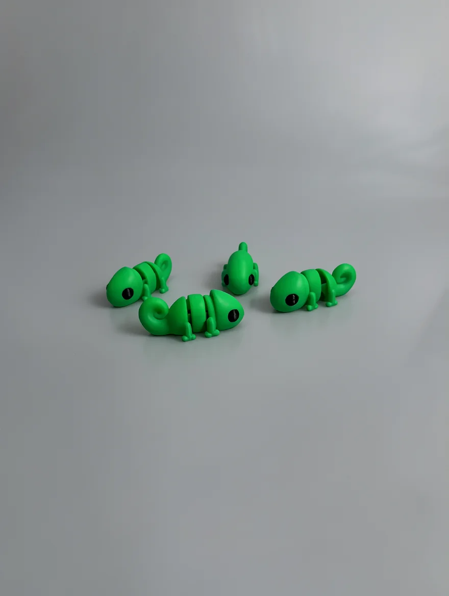 Baby Chameleon: green and black small lizard/chameleon figurine (articulated, segmented body)