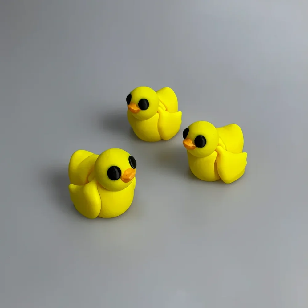 Baby Duck: yellow and black three identical miniature rubber duck figurines, two large glossy black circular eyes