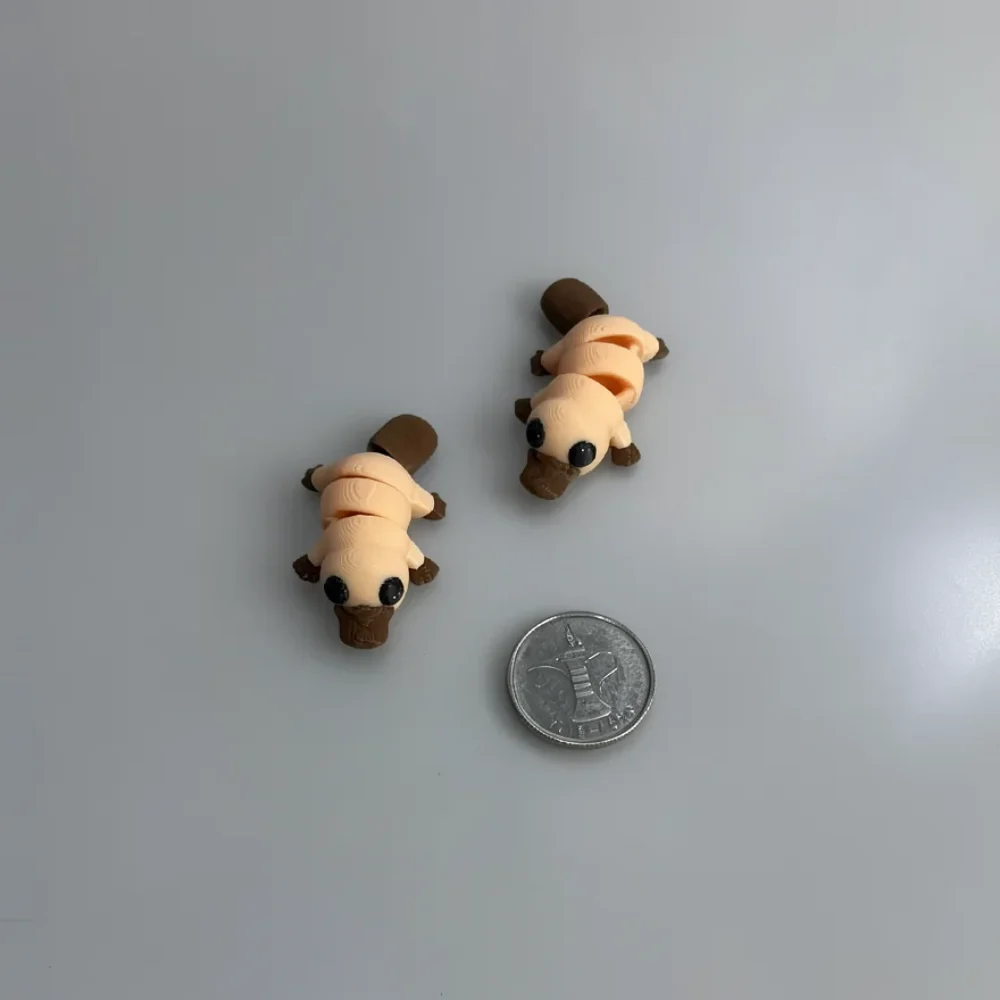 Baby Platypus: beige and brown articulated segmented larva/caterpillar figurine