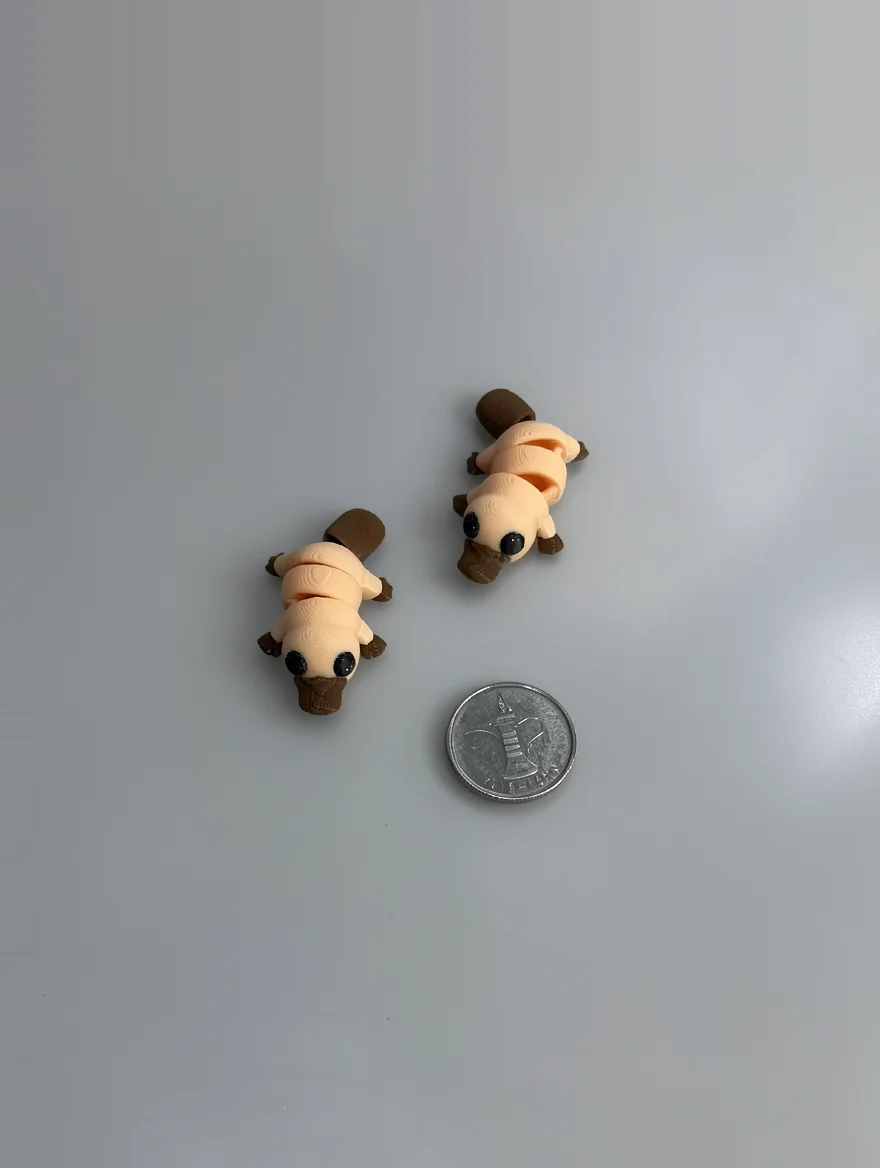Baby Platypus: beige and brown articulated segmented larva/caterpillar figurine