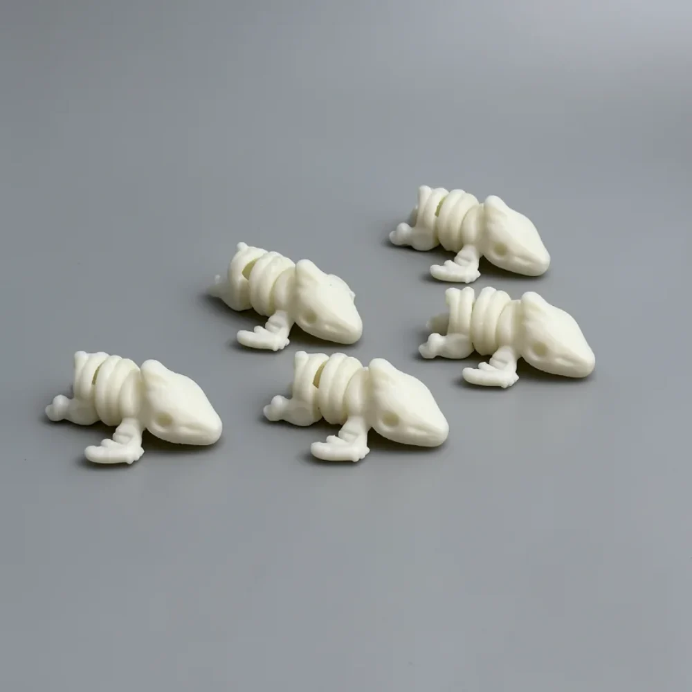 Baby Pterodactyl Skeleton: cream and off-white five identical small reptile-like creature figurines…