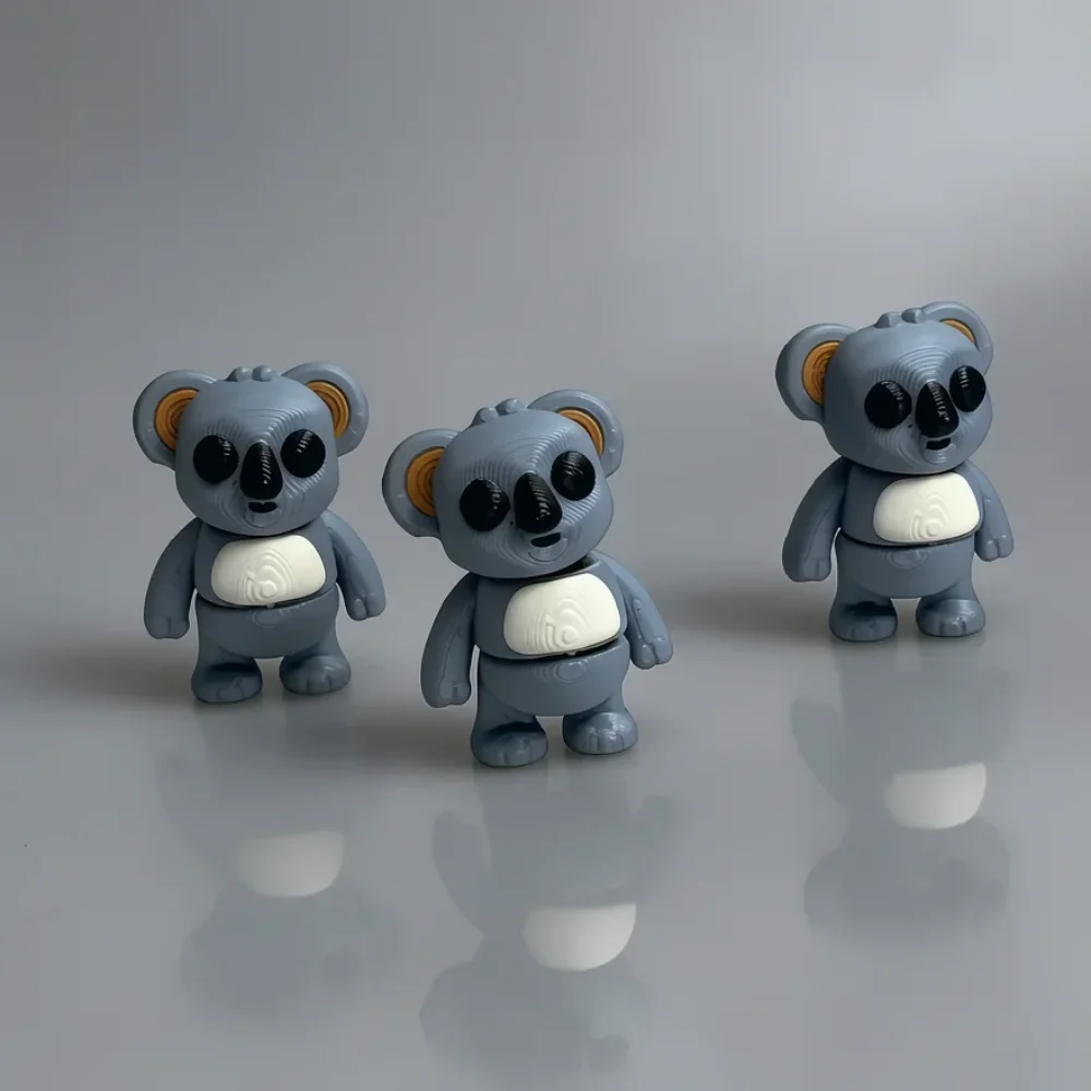 Tiny Koala Colorful: dusty blue-grey and white set of three identical koala figurines, large glossy black circular eyes