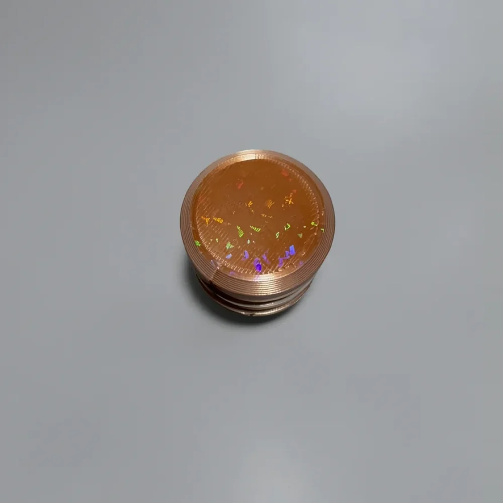 Two Way Screw: copper and bronze cylindrical container with screw-top lid, horizontal knurling ridges on sides