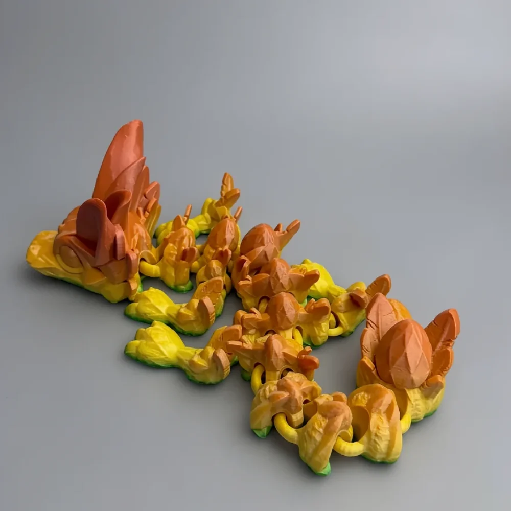 Baby Easter Dragon: yellow and orange low-poly dragon figurine, single articulated piece