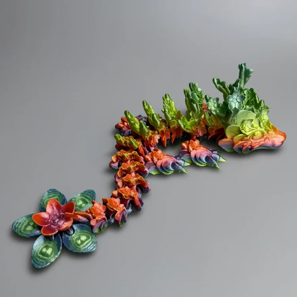 Baby Cherry Blossom Dragon: green and yellow multi-colored botanical sculpture with leaf clusters, flower elements, and…