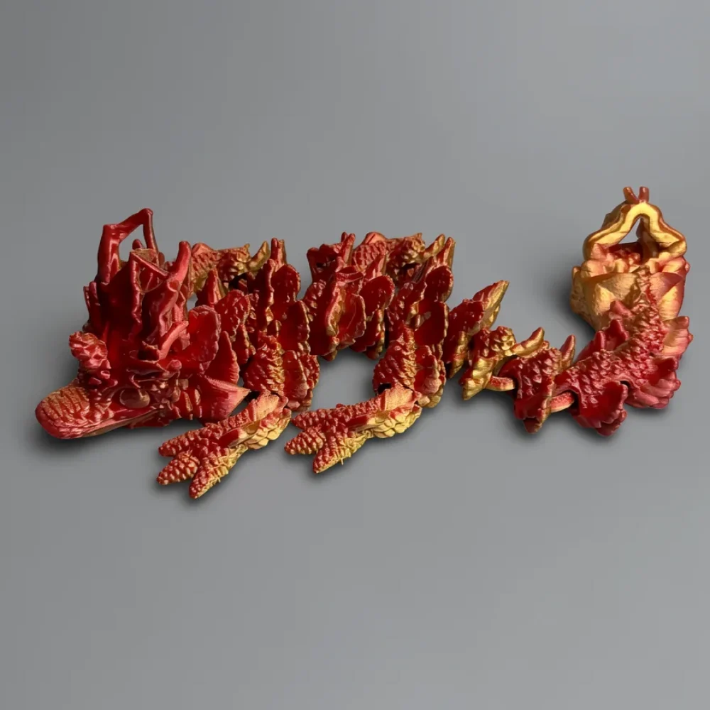 Baby Autumn Dragon: red and gold dragon figurine, overlapping scale-like segments resembling coral or succulent texture