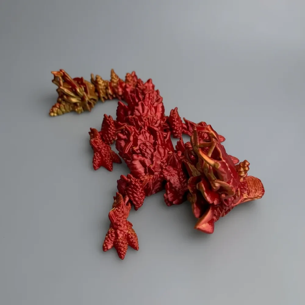 Baby Autumn Dragon: red and gold articulated dragon figurine, jagged overlapping scales
