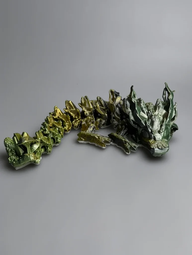Woodland Dragon: gold and green articulated dragon spine figurine, low-poly faceted surface