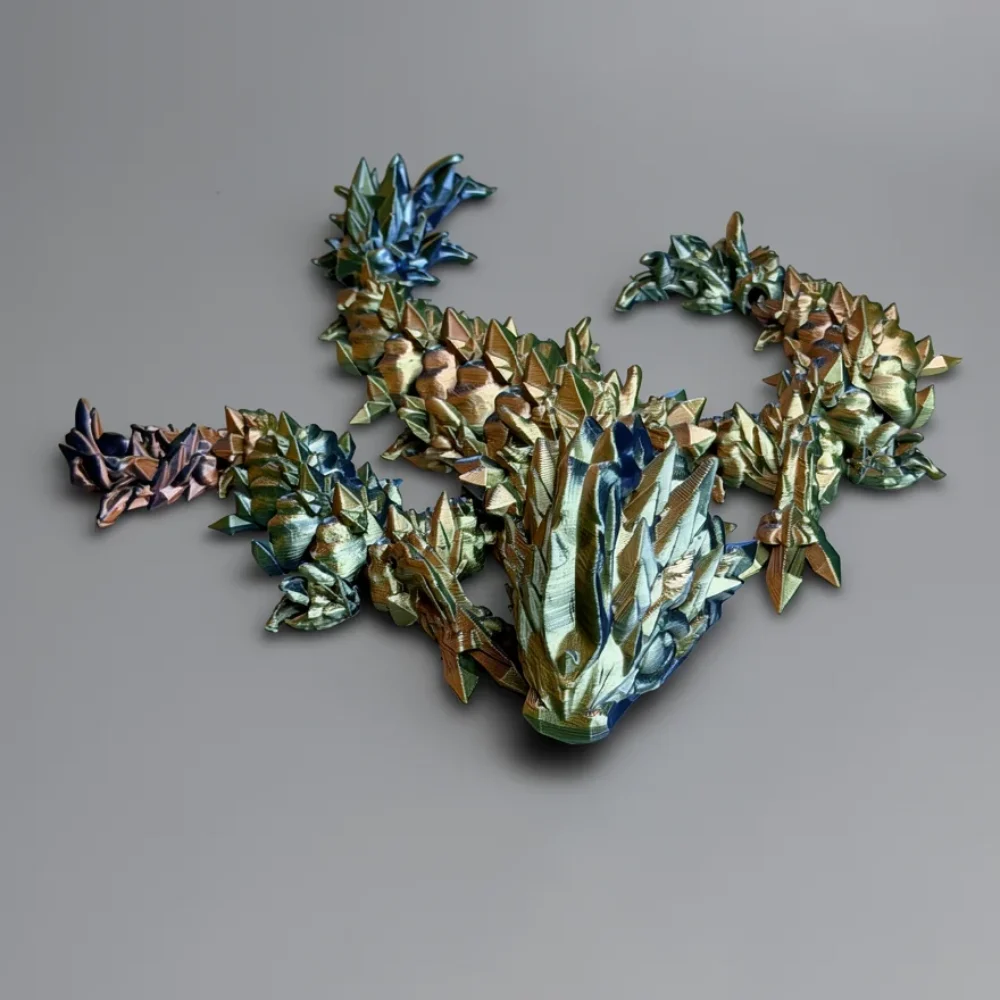 Baby Jellyfish Dragon: blue and gold dragon figurine, sharp faceted low-poly geometry
