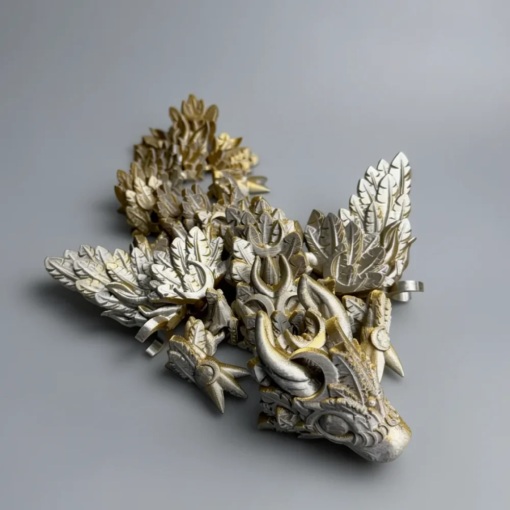 Baby Winged Lunar Dragon: silver and gold articulated dragon figurine, curved horns sweeping backward from head