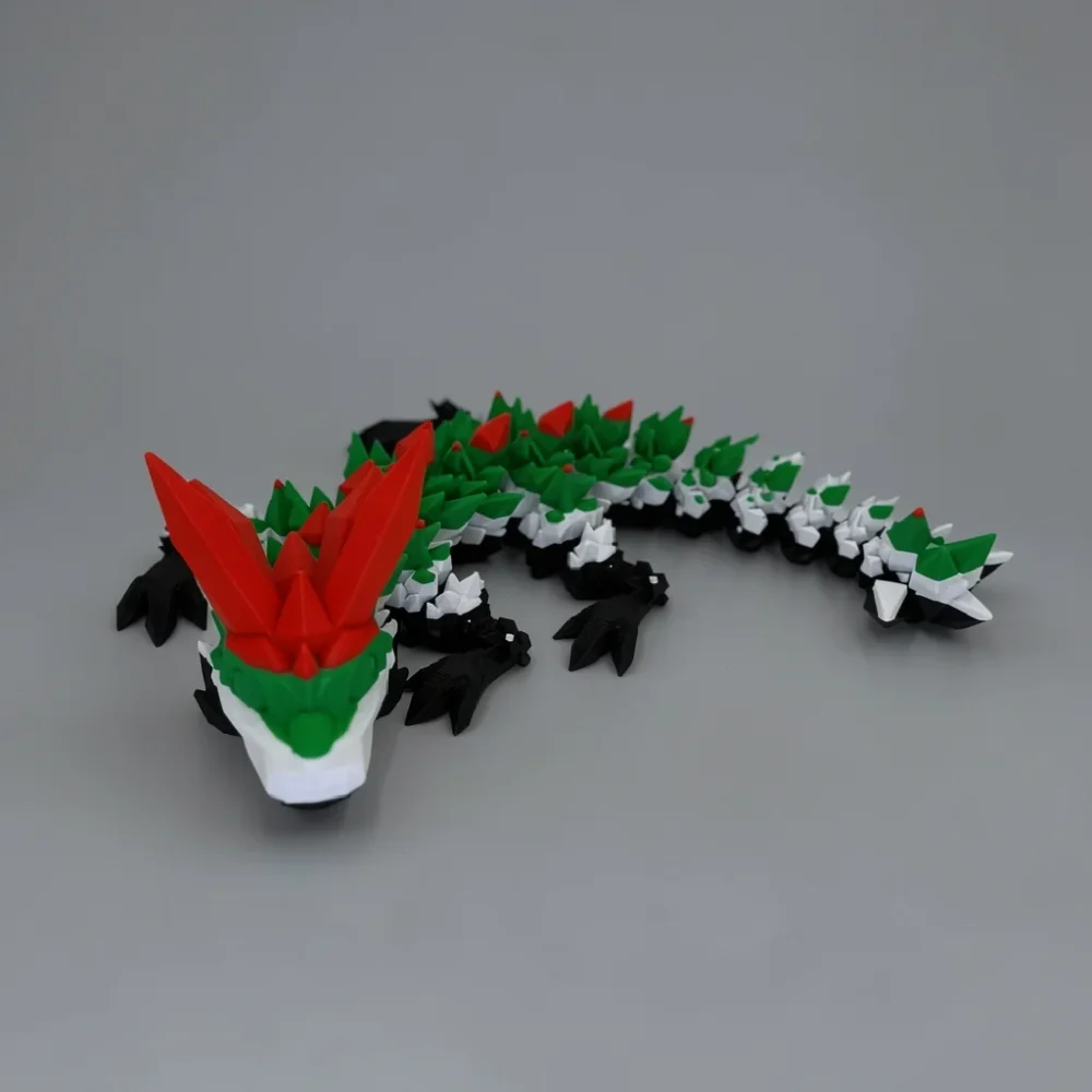 Baby Crystal Dragon: black and green segmented dragon figurine, low-poly faceted/crystalline body segments