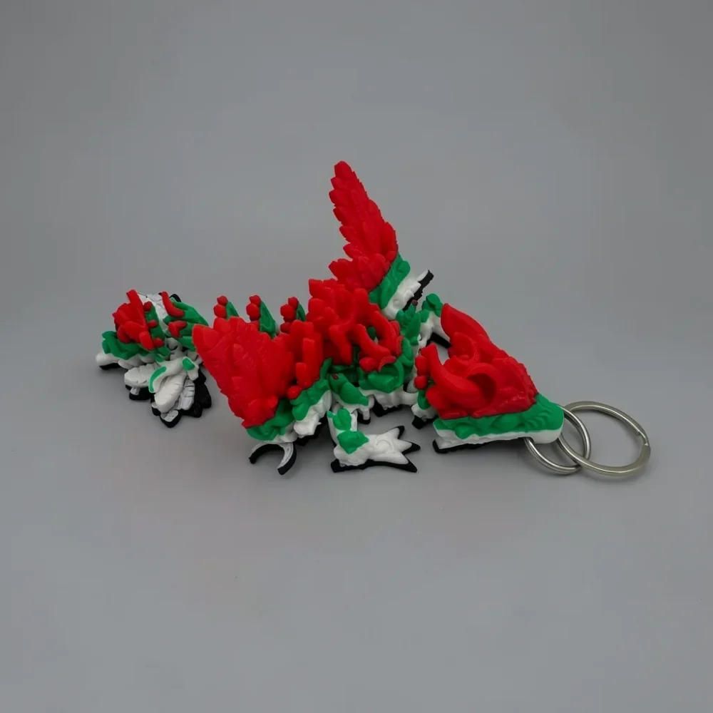 Winged Lunar Dragon: red and green dragon keychain, two silver metal split rings attached at tail base