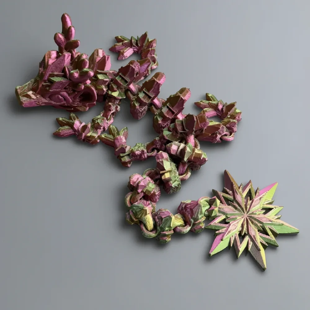 Baby Winter Dragon: magenta pink and lime green articulated dragon figurine, protruding snout facing left
