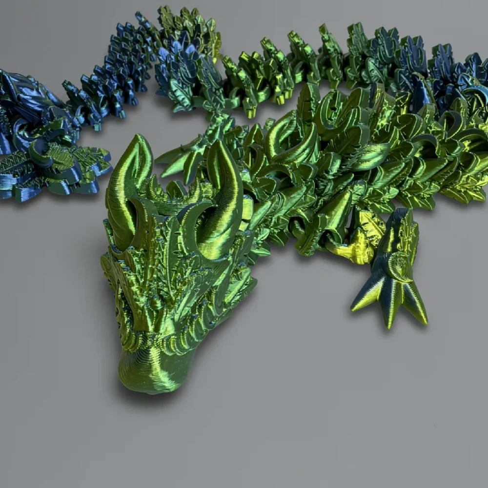 Lunar Dragon: green and blue articulated dragon figurine, two curved horns sweeping backward