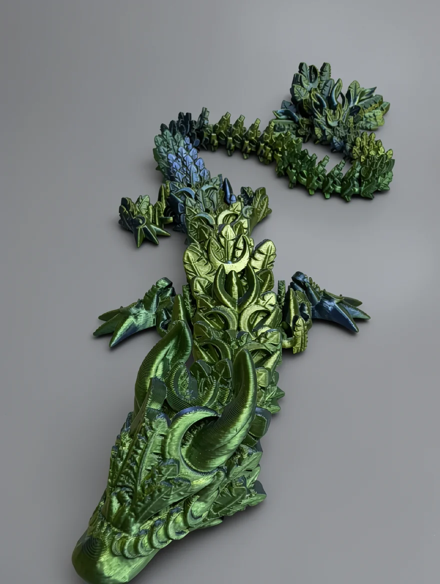 Lunar Dragon: metallic lime green and olive green articulated dragon figurine with a separate tail section, pointed snout