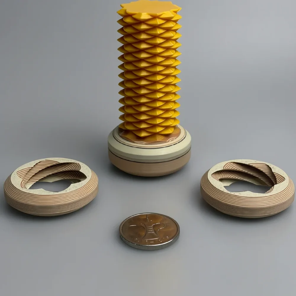 Two Way Screw – 7.5cm: yellow and tan/beige abstract geometric sculpture set: a faceted pleated column on a two-tone…