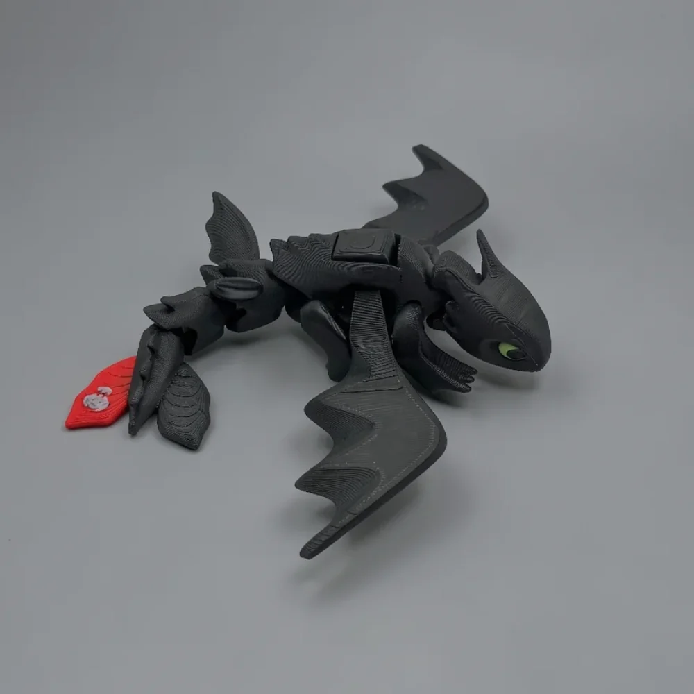 Toothless: black and green dragon figurine, single visible lime green eye