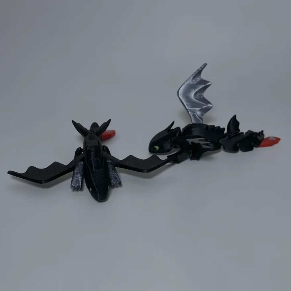 Toothless: black and lime green two dragon figurines, bat-like wings